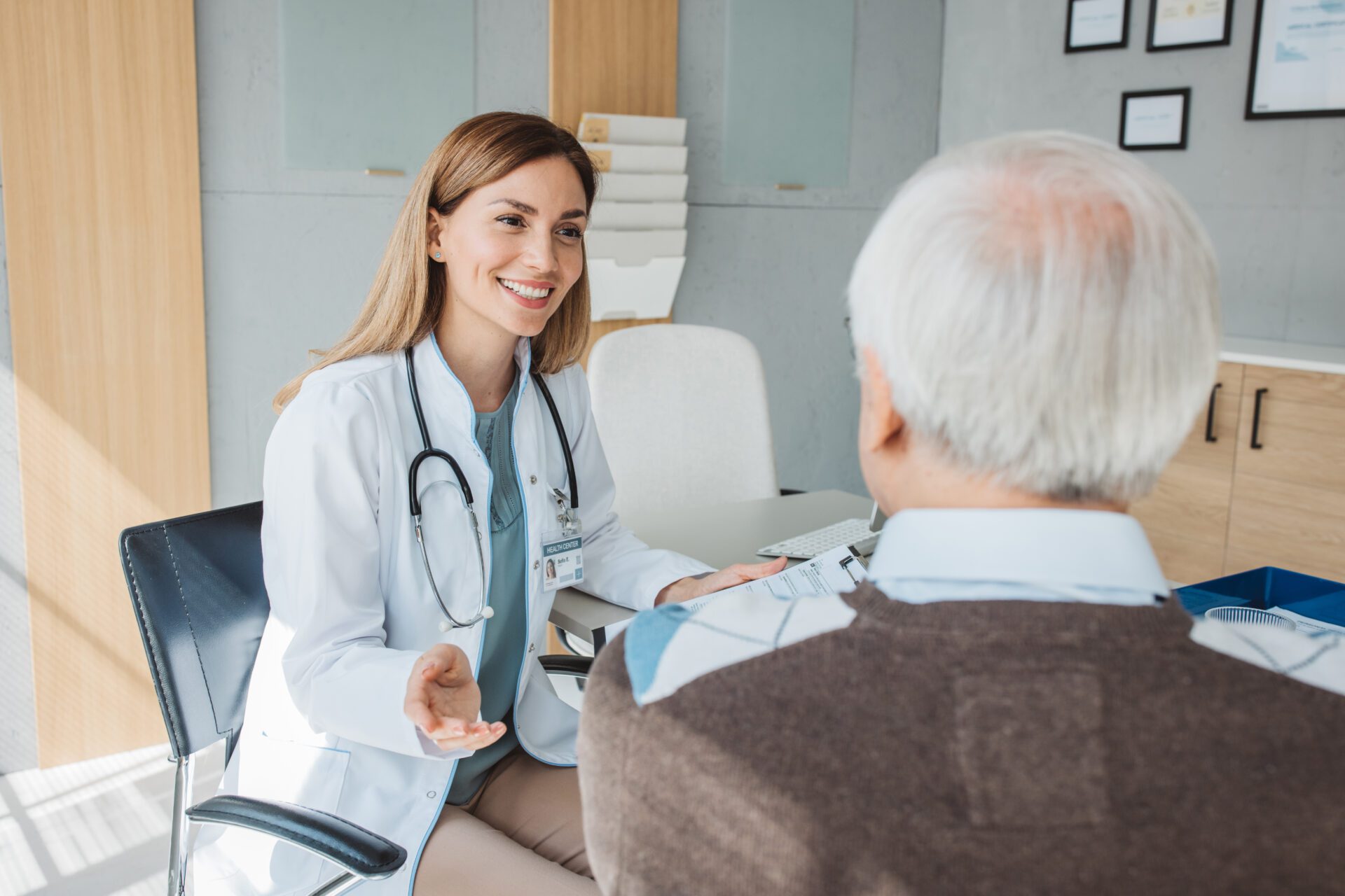 Doctor consulting with elderly patient in office.