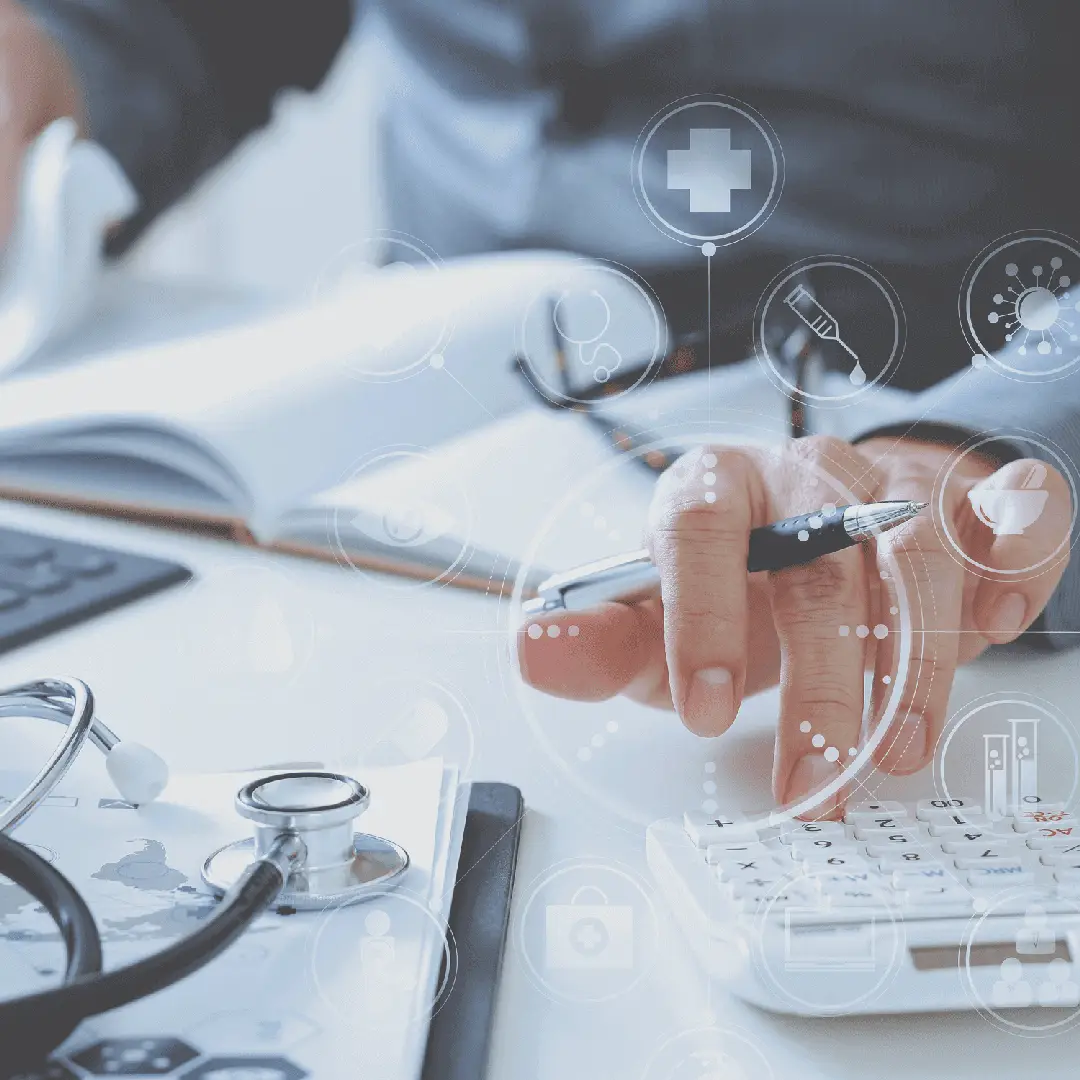 Doctor calculating medical expenses with calculator.